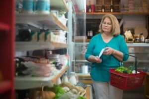 woman grocery shopping and saving money