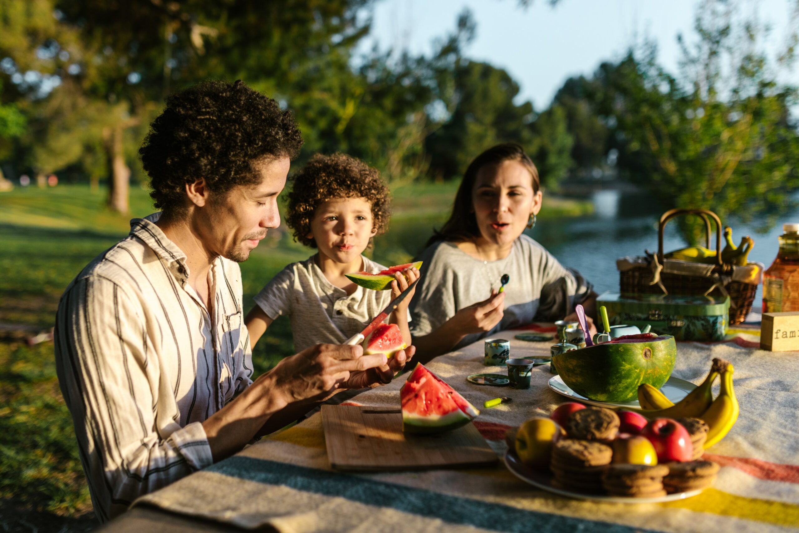 Family eating watermelon at a picnic