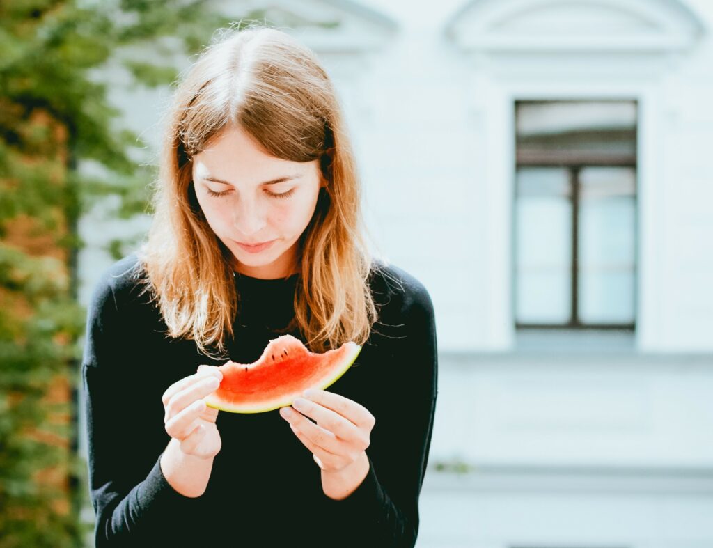 woman with an eating disorder eating watermelon