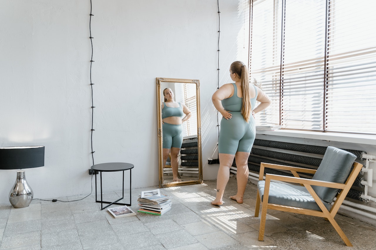 Woman with an eating disorder looking in a mirror