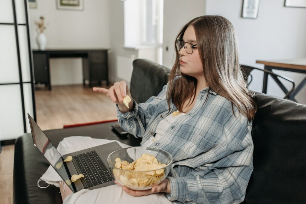 woman with an eating disorder eating chips