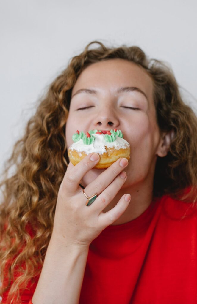 Woman eating a christmas donut