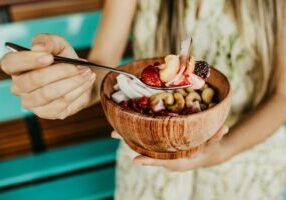 woman eating smoothie bowl in National Nutrition Month